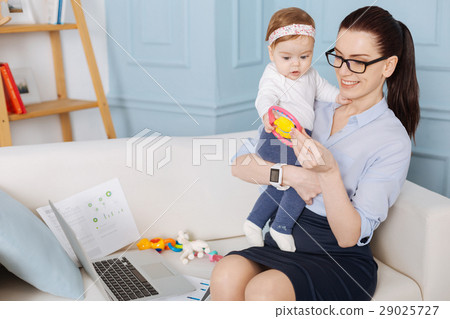 Sweet little lady fascinated about new toy 29025727