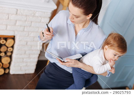 Energetic graceful businesswoman planning her day Energetic graceful businesswoman planning her day 29025793
