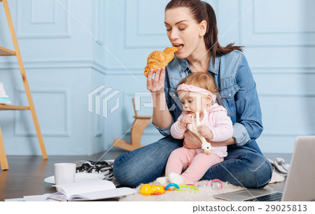 Busy inventive mom eating brunch with her daughter Busy inventive mom eating brunch with her daughter 29025813