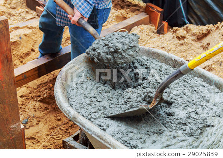 Worker pouring concrete to formwork construction 29025839
