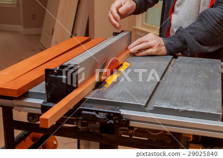 Carpenter's hands cutting wood tablesaw workshop 29025840