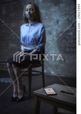 Hopeful scared woman looking at the phone 29025994