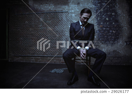 Helpless businessamn tied with heavy chains 29026177