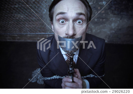 Horrified businessman desperate to escape from Horrified businessman desperate to escape from 29026220