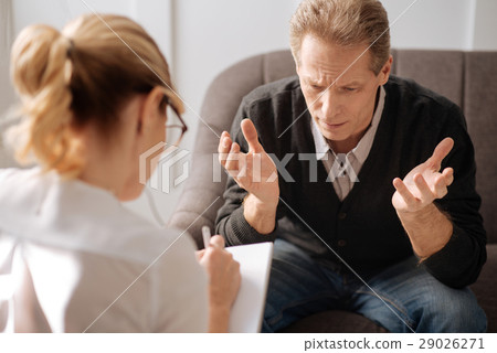Unhappy depressed man speaking about his problems 29026271