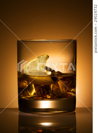 A glass of cocktail with lemon and ice A glass of cocktail with lemon and ice 29029732