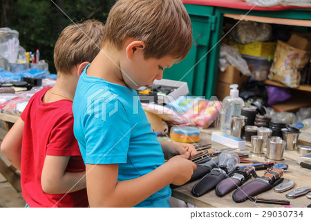 Two boys looking at souvenirs in market 29030734