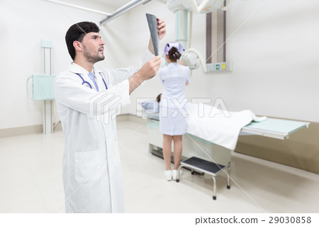 Doctor examining x-ray image in hospital room 29030858