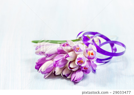 Bouquet of crocuses on a wooden table 29033477