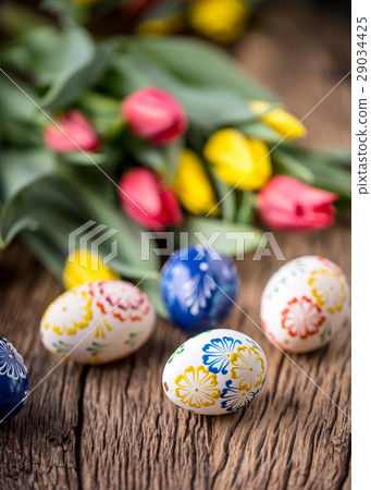 Easter. Hand made easter eggs and spring tulips. Easter. Hand made easter eggs and spring tulips. 29034425