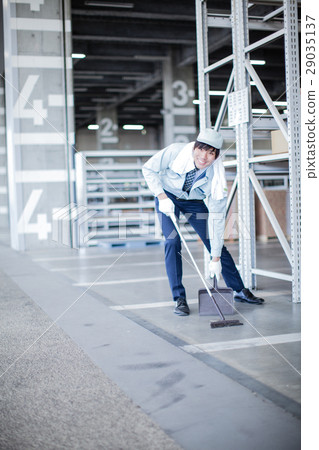 Workers cleaning the warehouse 29035137