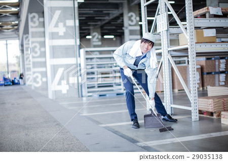 Workers cleaning the warehouse 29035138