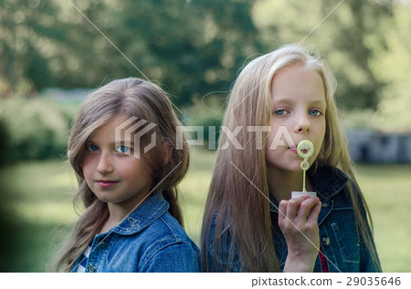 Portrait of two little girls enjoying summers. 29035646