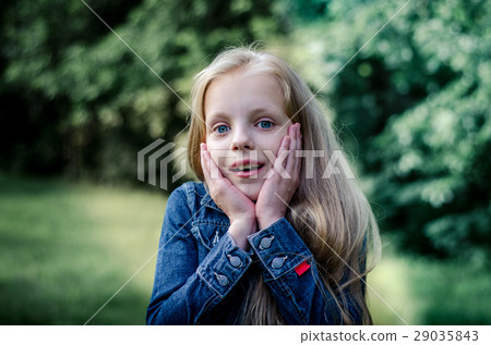 Surprised cute little blond girl at summer field. Surprised cute little blond girl at summer field. 29035843