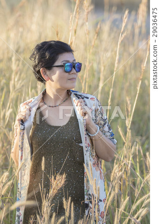 portrait of asian woman wearing sun glasses standing with relaxi portrait of asian woman wearing sun glasses standing with relaxi 29036475