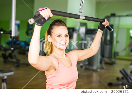 The woman shakes her muscles on the simulator in 29036571