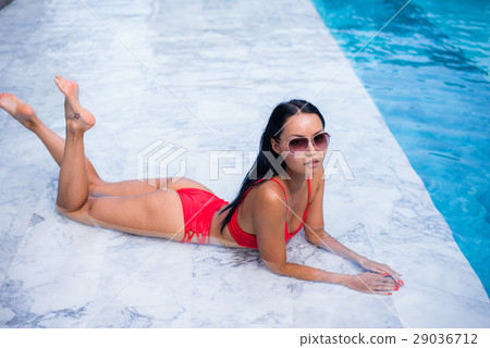 Sexy woman laying and relaxed near pool at cool 29036712