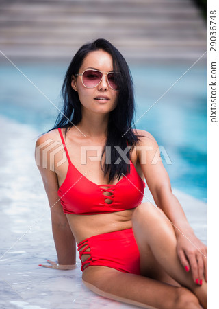 Elegant sexy woman in the red bikini on the sun Elegant sexy woman in the red bikini on the sun 29036748