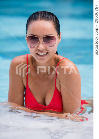 Tenned beautiful asian woman in orange bikini and Tenned beautiful asian woman in orange bikini and 29036767