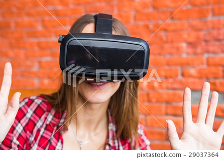 Young Woman Wearing Virtual Reality Headset Young Woman Wearing Virtual Reality Headset 29037364