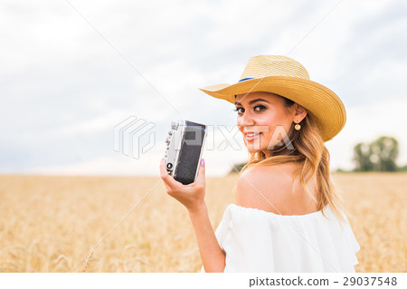 female photographer in the field with a camera female photographer in the field with a camera 29037548