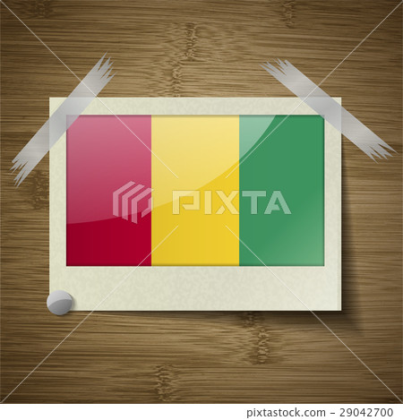 Flags Guinea at frame on wooden texture. Vector 29042700