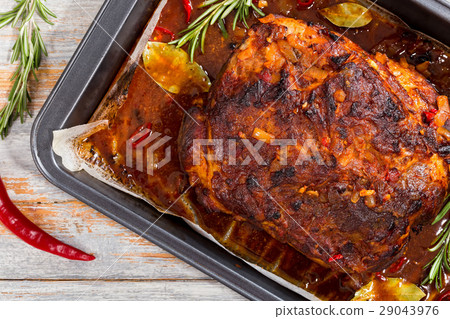 Whole roast shoulder of pork in roasting pan 29043976