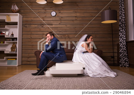 Unhappy family couple sitting on the table Unhappy family couple sitting on the table 29046894