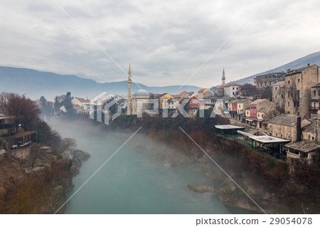 View of Mostar Old Town and Green Neretva River from Stari Most of Fog Day 29054078