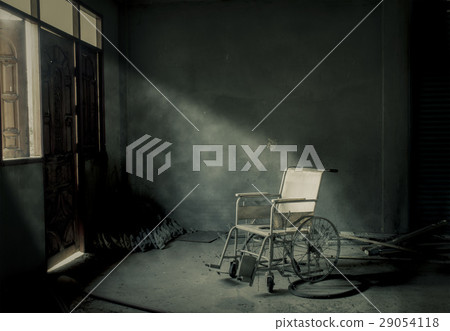 an old wheelchair in old room 29054118