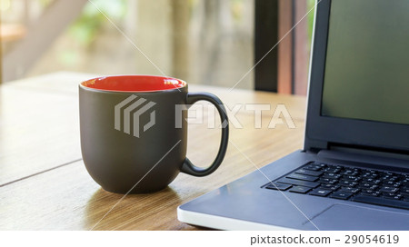 The black cup of coffee and laptop. The black cup of coffee and laptop. 29054619