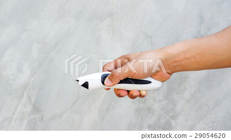 Man holding wireless hair clipper in his hand. Man holding wireless hair clipper in his hand. 29054620