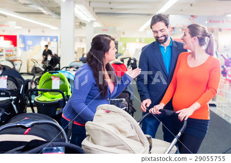 Woman, man, and sales lady in baby store 29055755