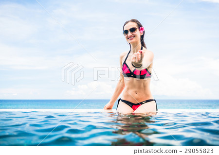 Woman making wooing gesture at edge  29055823