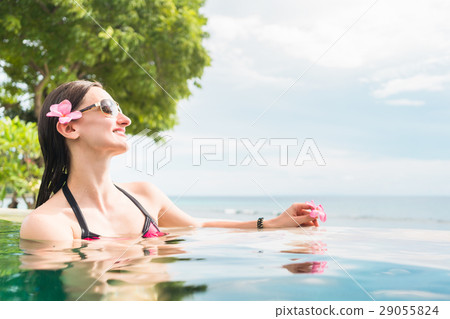 Woman in vacation relaxing swimming in pool Woman in vacation relaxing swimming in pool 29055824