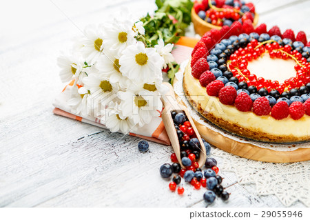 Raspberry and blueberry cheesecake on wooden table Raspberry and blueberry cheesecake on wooden table 29055946