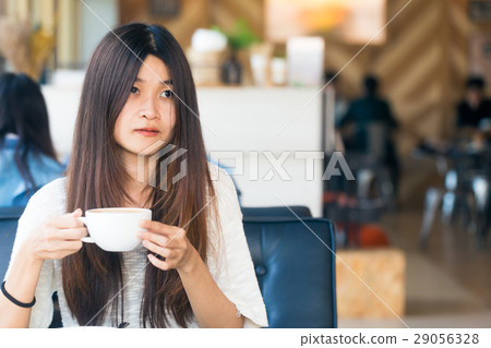 women in library with cup of coffee to make a idea 29056328