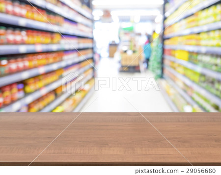 Wooden empty table in front of blurred supermarket Wooden empty table in front of blurred supermarket 29056680