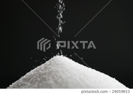 extra small salt crystals fall on black background extra small salt crystals fall on black background 29059653