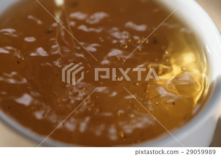macro photo of pouring puerh tea in cup 29059989