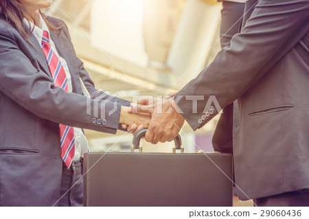 Business man and businesswoman handshake at city 29060436