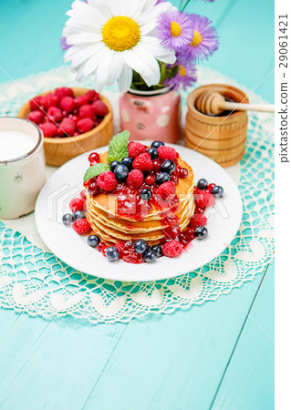 Stack of pancakes on wooden background 29061421