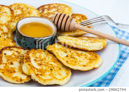 Pancakes on plate and honey in small bowl Pancakes on plate and honey in small bowl 29062744