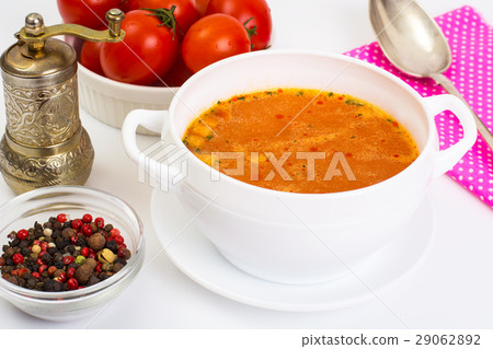 Spicy soup with tomatoes and curry on a white Spicy soup with tomatoes and curry on a white 29062892