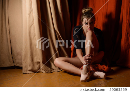 Ballerina sitting on the stage. looking at camera Ballerina sitting on the stage. looking at camera 29063269