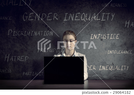 Woman works at her desk in a dark room. 29064182