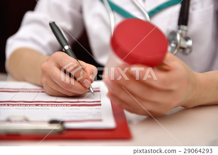 Nurse holding container with tablet Nurse holding container with tablet 29064293