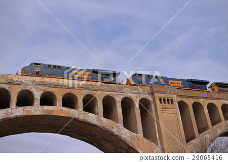 American double locomotive car crossing a stone bridge 29065416