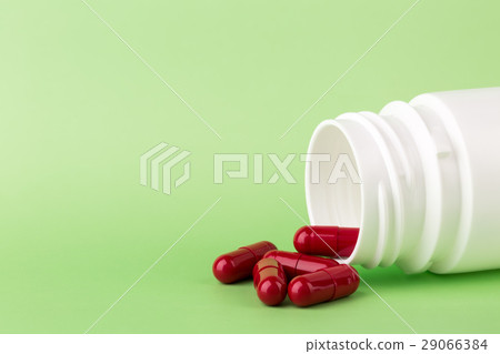 Red pills and a bottle of medicine 29066384