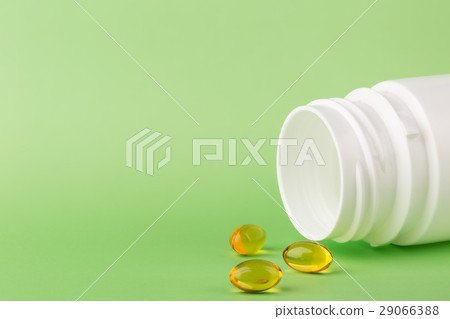 Fish oil pills and a bottle of medicine 29066388